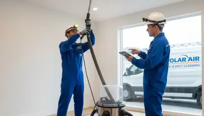 Technician providing air duct cleaning service for residential HVAC system in Cleveland, OH